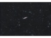 NGC 4216 ist eine Balken-Spiralgalaxie vom Hubble-Typ SBb im Sternbild Jungfrau am Nordsternhimmel. Sie ist schätzungsweise 53 Millionen Lichtjahre von der Milchstraße entfernt und hat einen Durchmesser von etwa 130.000 Lichtjahren.
Bei dem Objekt handelt es sich um eine sogenannte Edge-On-Galaxie, d. h. wir sehen sie nahezu in Kantenstellung. Die Spiralarme erscheinen hier als dunkle staubhaltige Wolken, beleuchtet vom hellen Kern der Galaxie.
Im Bild sind darüber ist noch NGC4206, links darunter NGC4222, sowie ein paar weitere Objekte zu sehen.